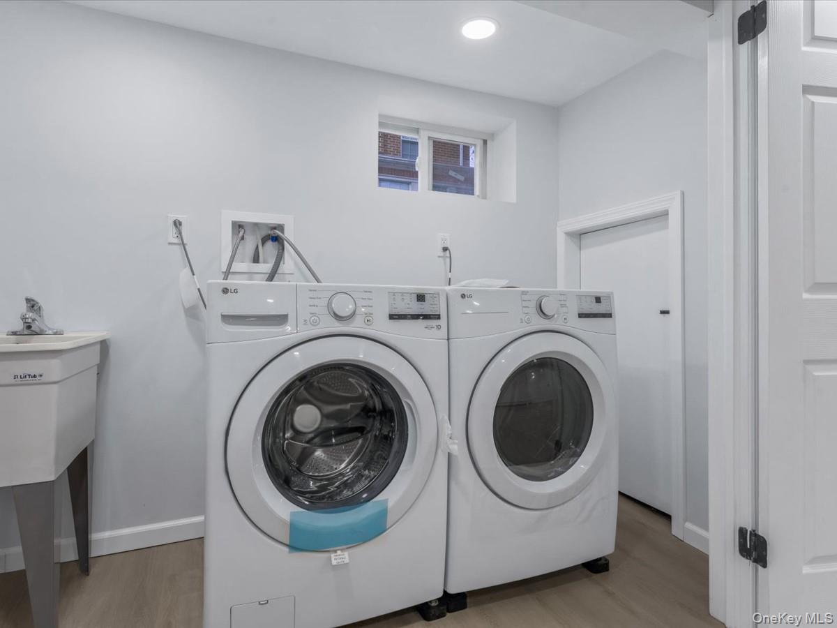62 Essex Road Great Neck, NY 11023 - Photo 21 of 25 a utility room with sink dryer and washer