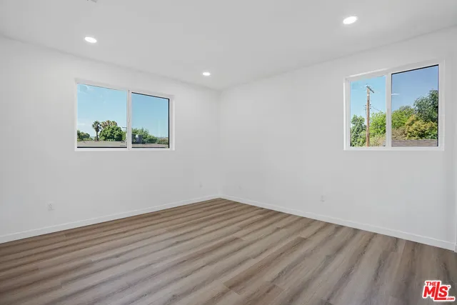a view of room with wooden floor and window