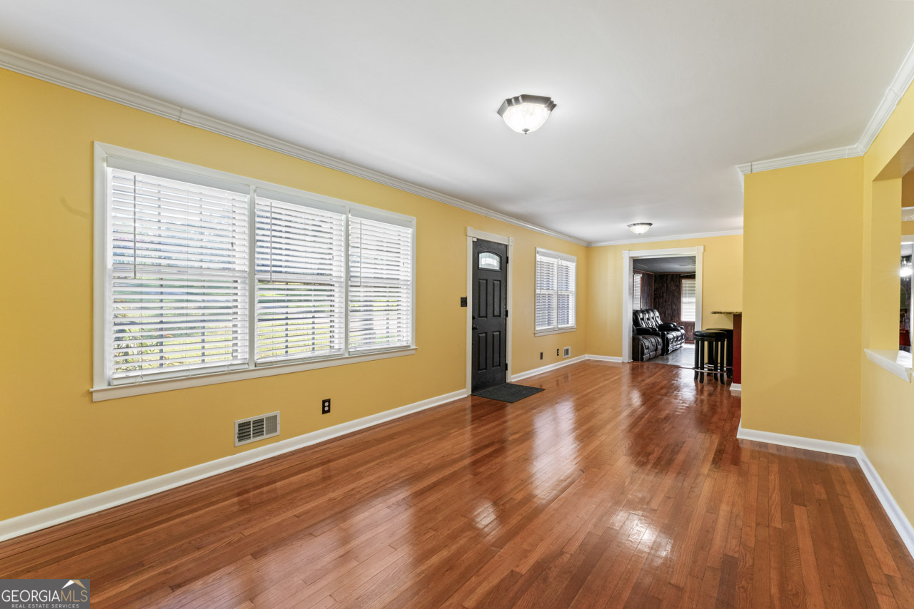 515 Valley Hill Road Stockbridge, GA 30281 - Photo 11 of 44 a view of an empty room with wooden floor and a window