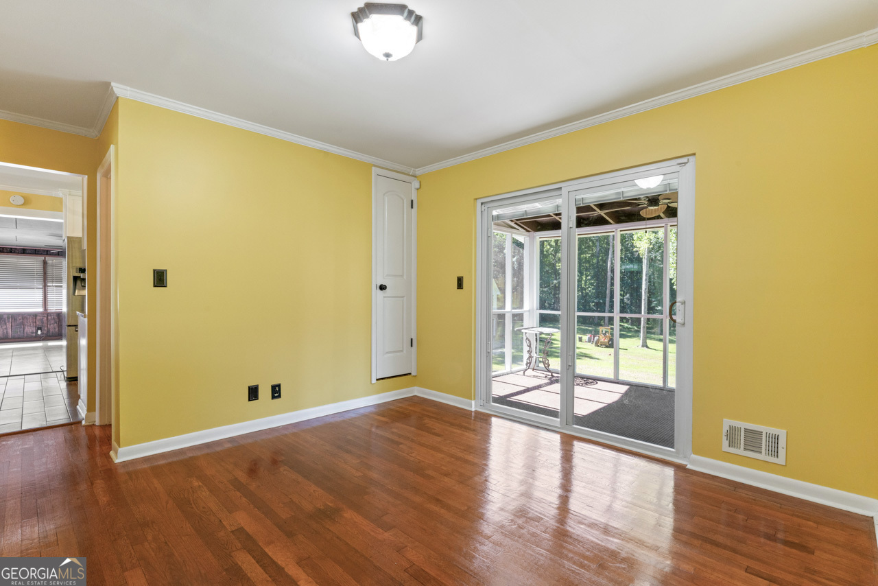 515 Valley Hill Road Stockbridge, GA 30281 - Photo 16 of 44 an empty room with wooden floor and windows