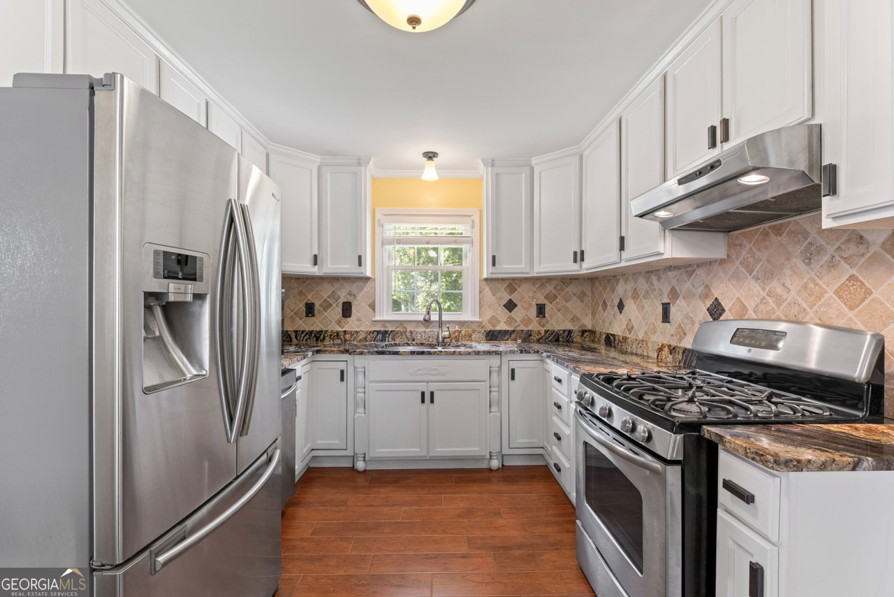 515 Valley Hill Road Stockbridge, GA 30281 - Photo 20 of 44 a kitchen with stainless steel appliances granite countertop a stove a refrigerator and a stove