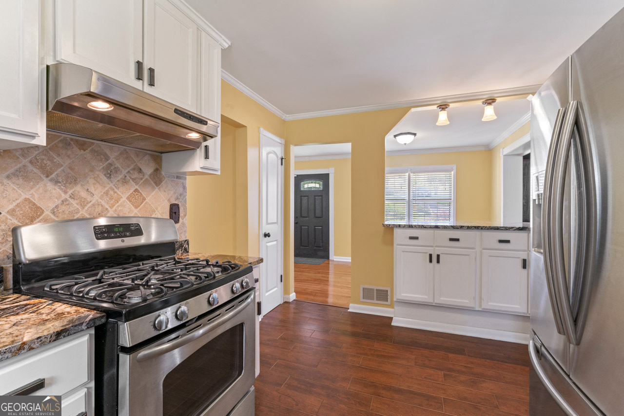 515 Valley Hill Road Stockbridge, GA 30281 - Photo 22 of 44 a kitchen with stainless steel appliances granite countertop a stove and a refrigerator