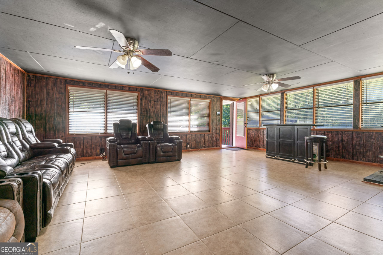 515 Valley Hill Road Stockbridge, GA 30281 - Photo 23 of 44 a living room with couches a dining table and chairs with outer view