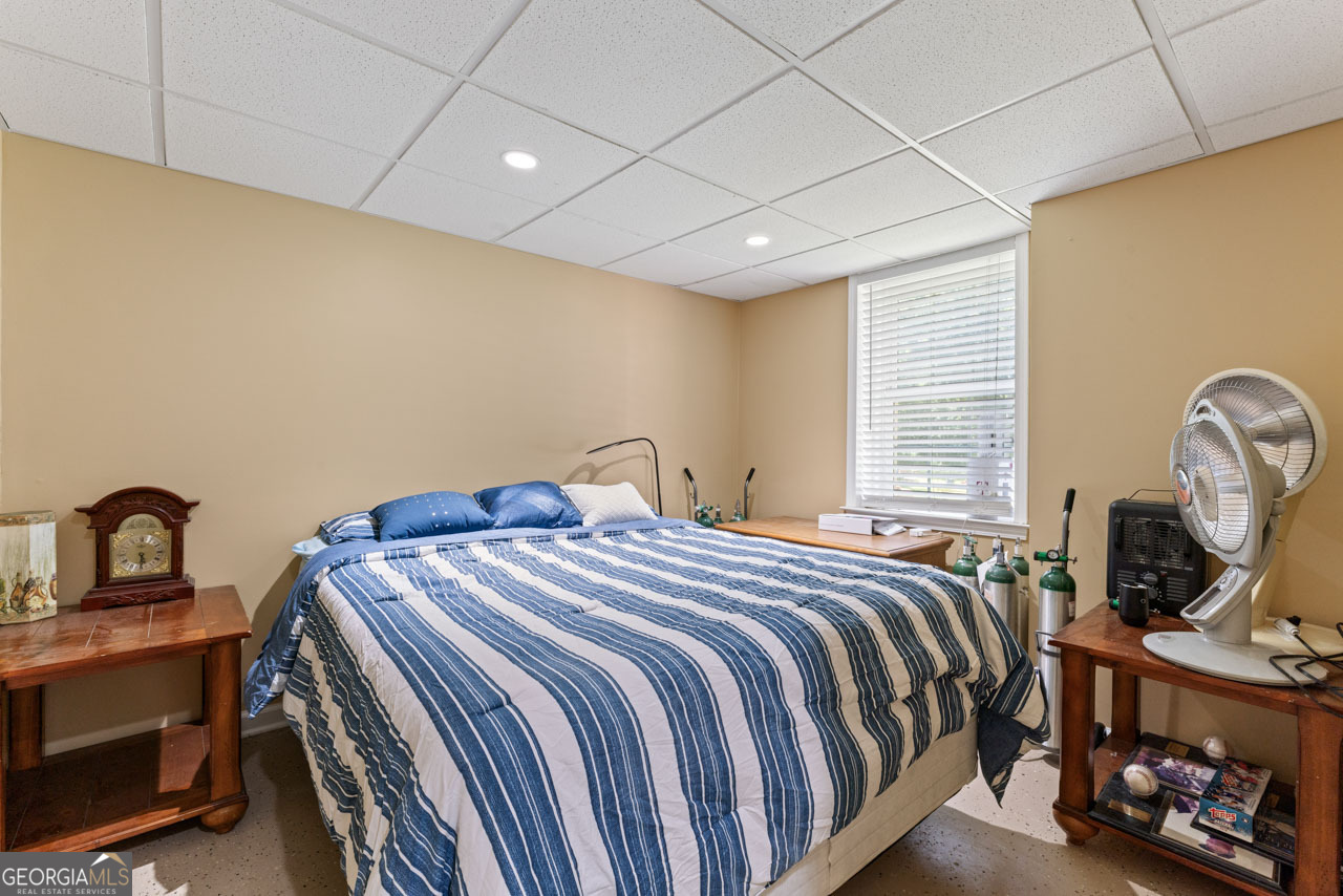 515 Valley Hill Road Stockbridge, GA 30281 - Photo 28 of 44 a bedroom with a bed a dresser and windows