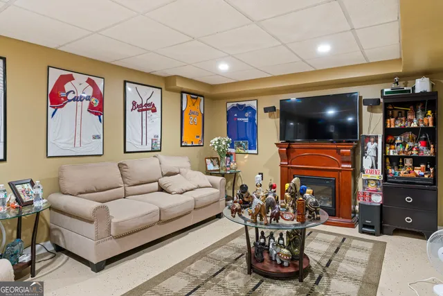 a living room with fireplace furniture and a chandelier