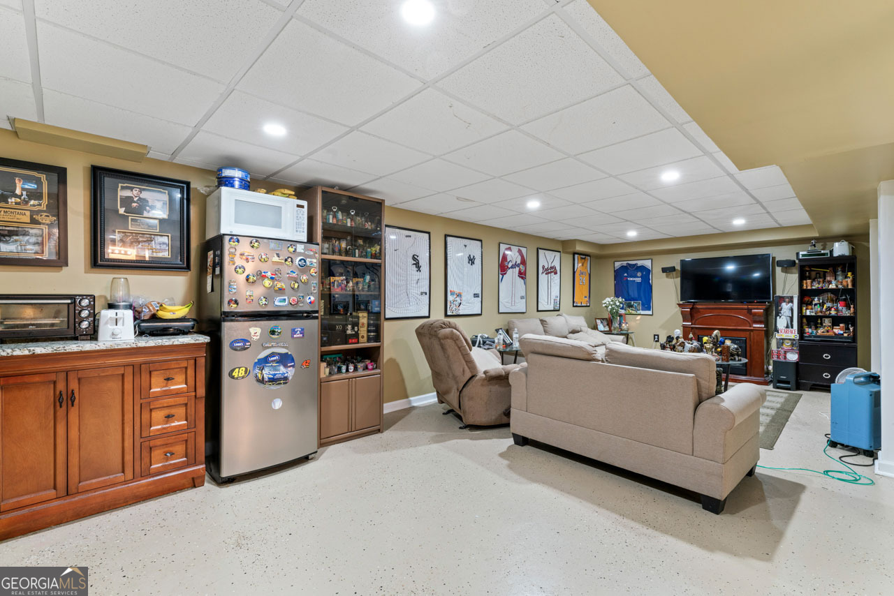 515 Valley Hill Road Stockbridge, GA 30281 - Photo 31 of 44 a living room with furniture and a flat screen tv