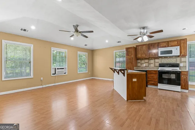 a kitchen with stainless steel appliances granite countertop a stove a sink and a refrigerator