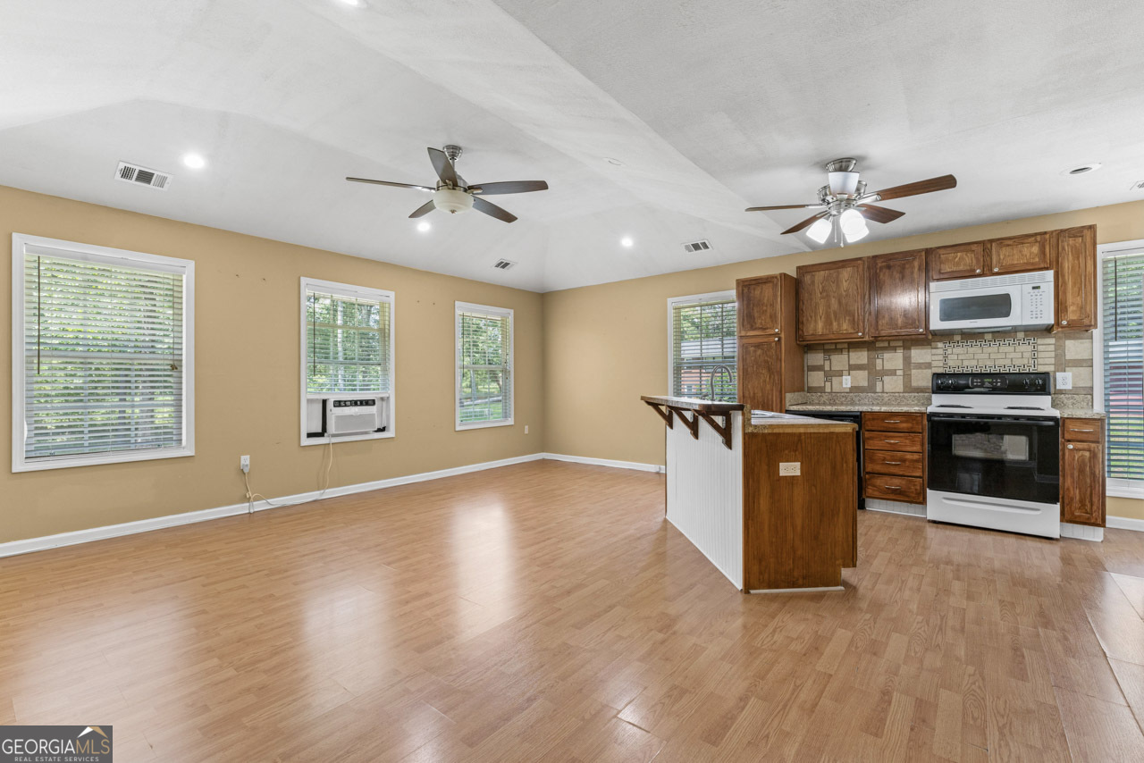 515 Valley Hill Road Stockbridge, GA 30281 - Photo 36 of 44 a kitchen with stainless steel appliances granite countertop a stove a sink and a refrigerator