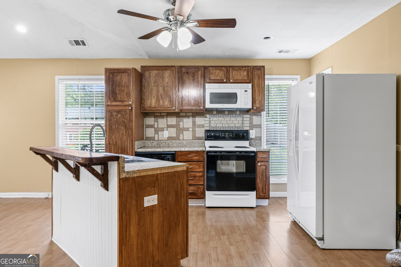 515 Valley Hill Road Stockbridge, GA 30281 - Photo 39 of 44 a kitchen with stainless steel appliances a refrigerator a stove a sink and a microwave