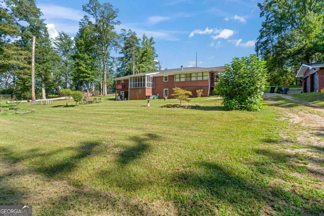 a view of a yard with a house in the background