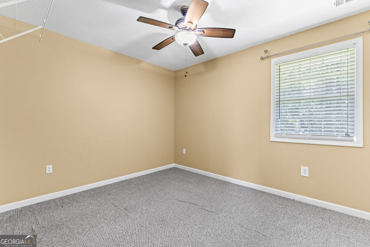 515 Valley Hill Road Stockbridge, GA 30281 - Photo 44 of 44 an empty room with a window and a fan