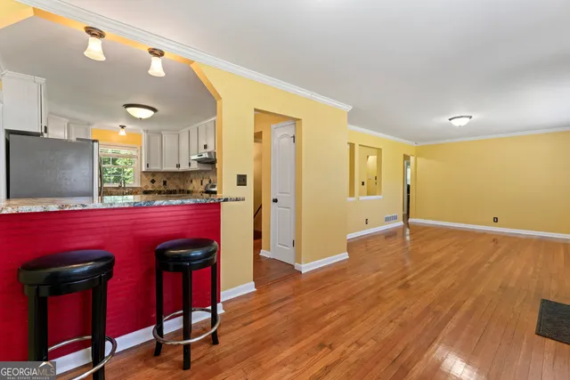a view of kitchen with a table and chairs