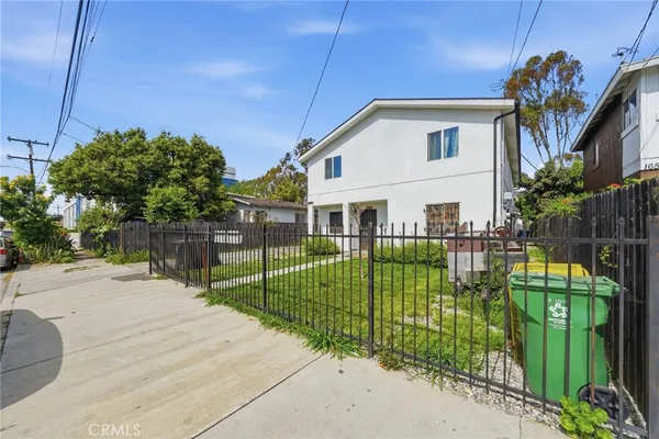a view of a house with a small yard and plants