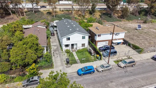 an aerial view of a house with garden space and street view