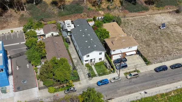 an aerial view of a house with outdoor space