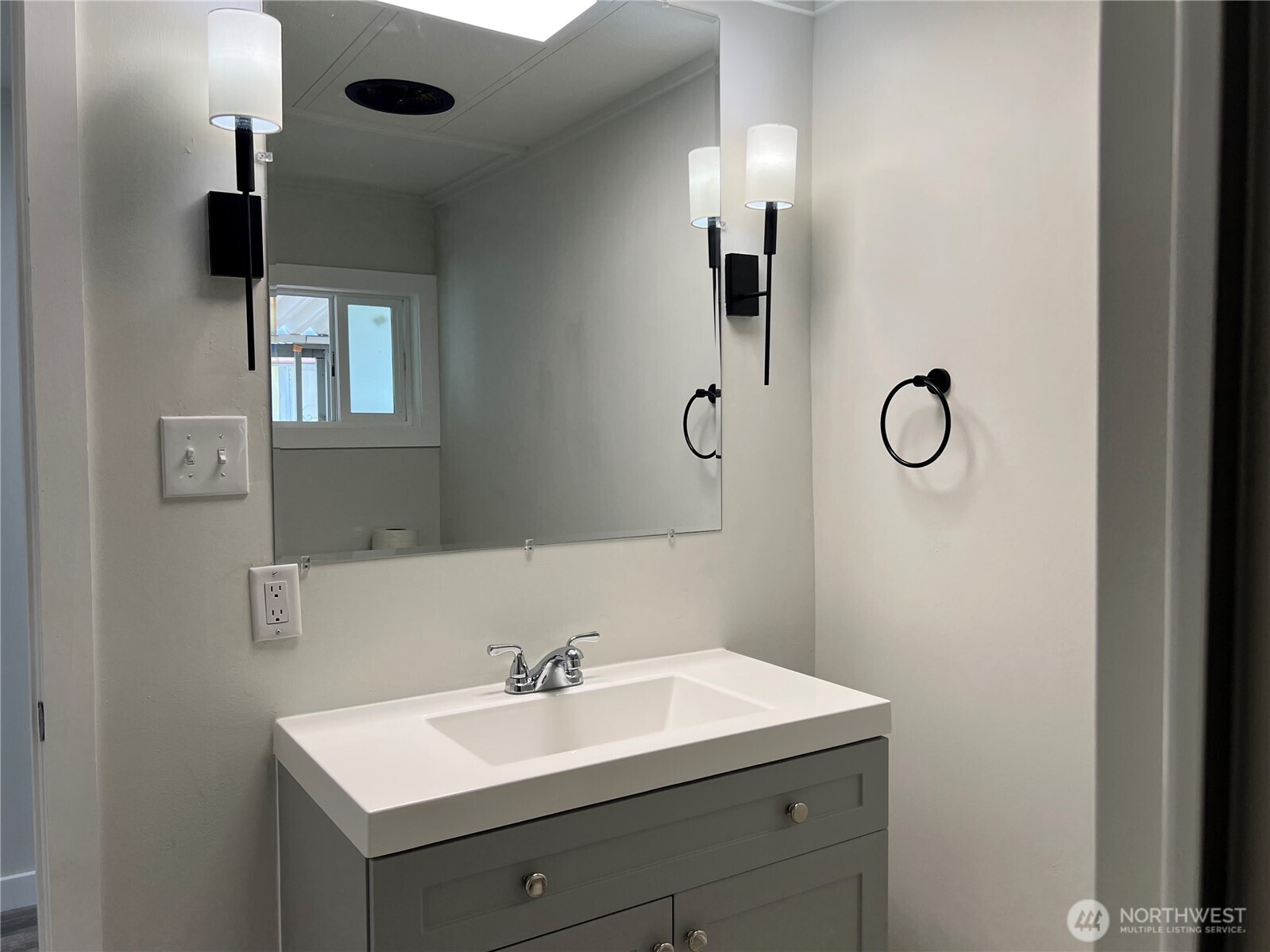18501 52nd Avenue West, Unit 84 Lynnwood, WA 98037 - Photo 14 of 32 a bathroom with a sink a light fixture and a mirror