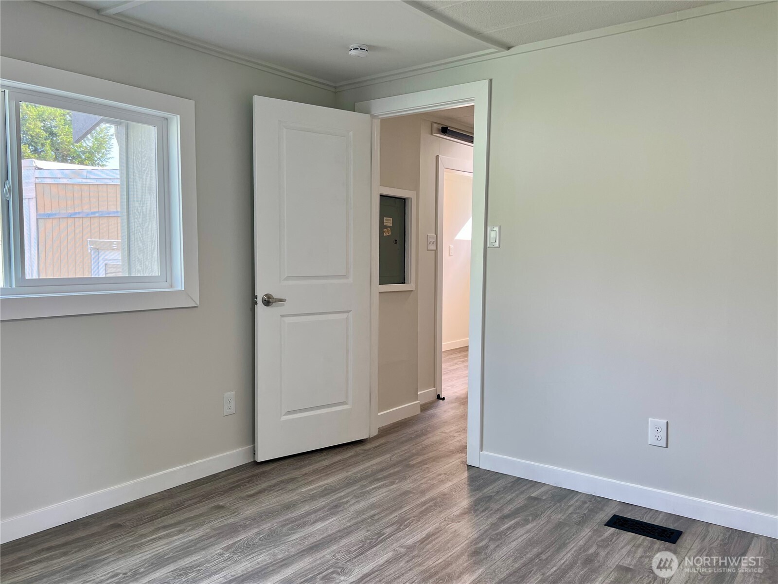 18501 52nd Avenue West, Unit 84 Lynnwood, WA 98037 - Photo 16 of 32 an empty room with wooden floor and windows