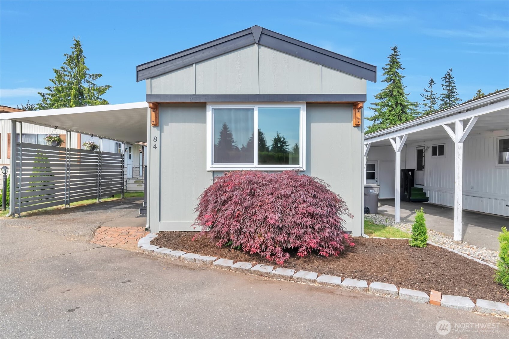 18501 52nd Avenue West, Unit 84 Lynnwood, WA 98037 - Photo 22 of 32 a view of a house with a garage and outdoor space