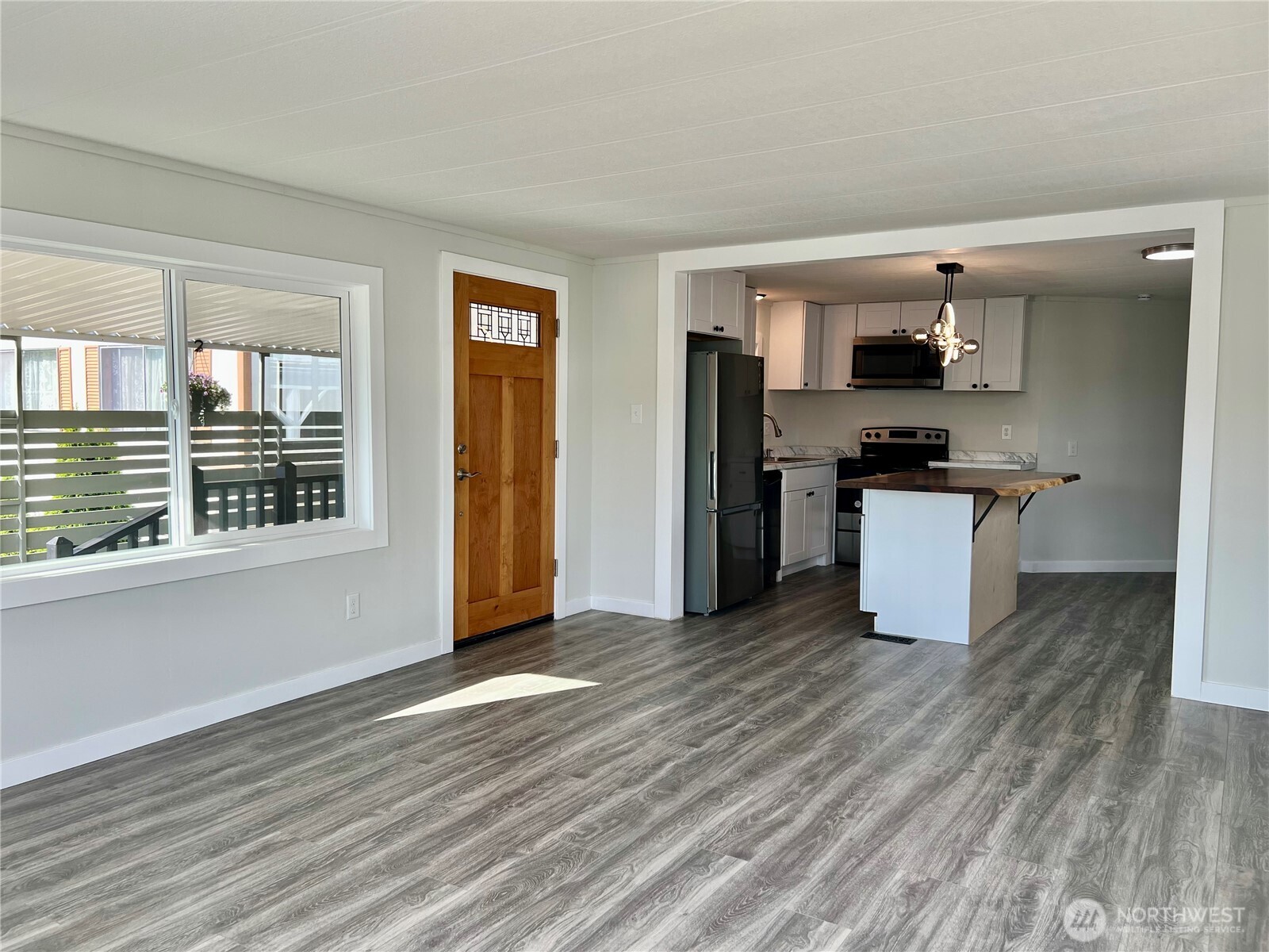 18501 52nd Avenue West, Unit 84 Lynnwood, WA 98037 - Photo 3 of 32 a kitchen with stainless steel appliances wooden floor and a window