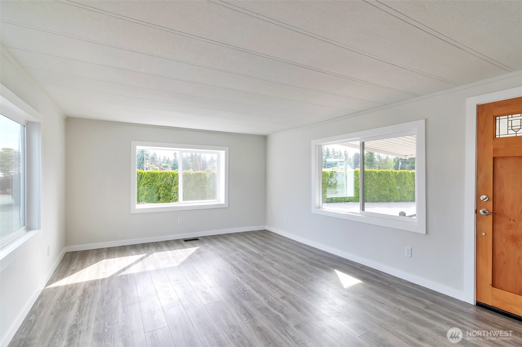 18501 52nd Avenue West, Unit 84 Lynnwood, WA 98037 - Photo 4 of 32 a view of an empty room with wooden floor and a window