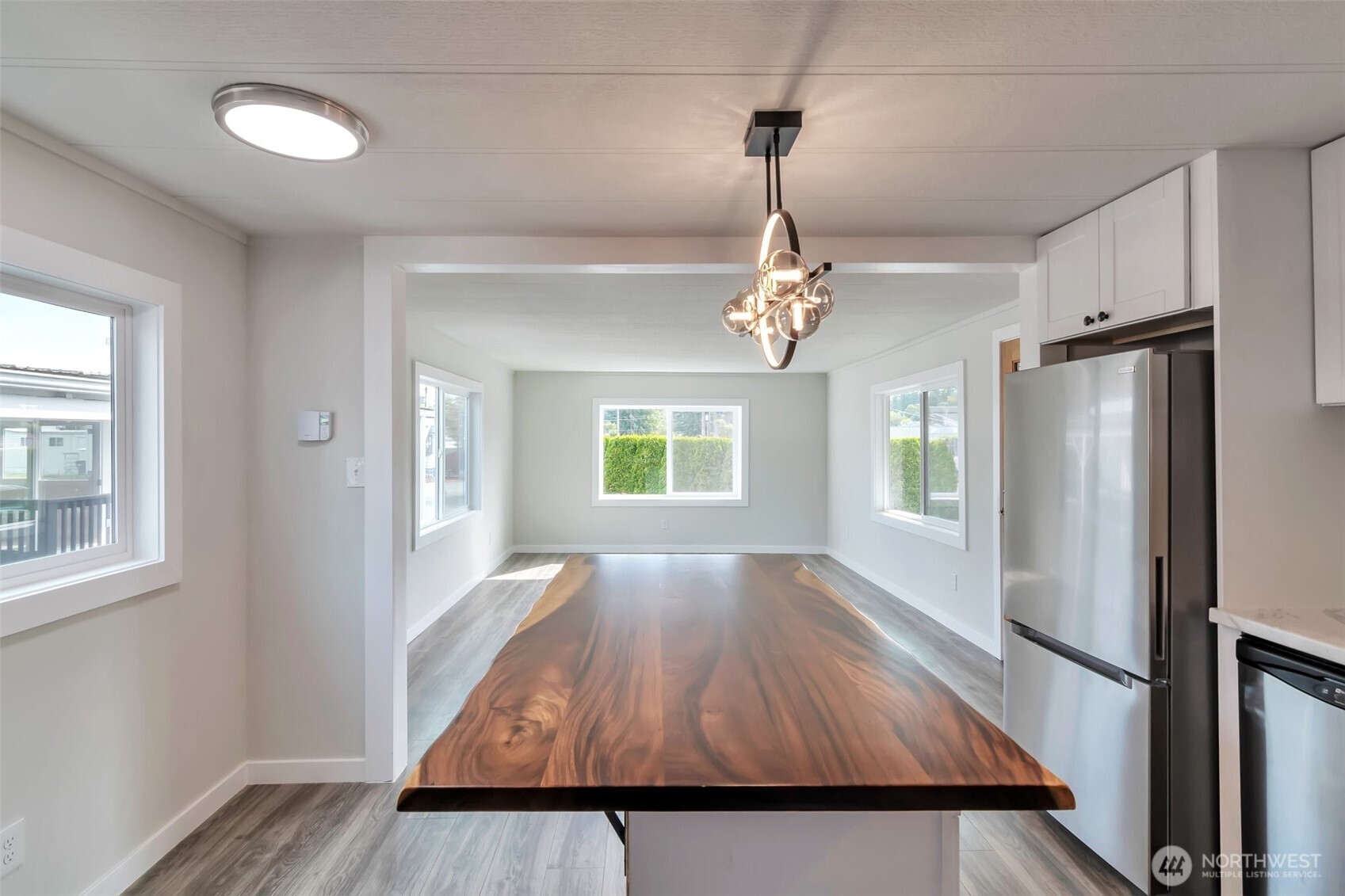 18501 52nd Avenue West, Unit 84 Lynnwood, WA 98037 - Photo 7 of 32 a view of empty room with wooden floor and fan