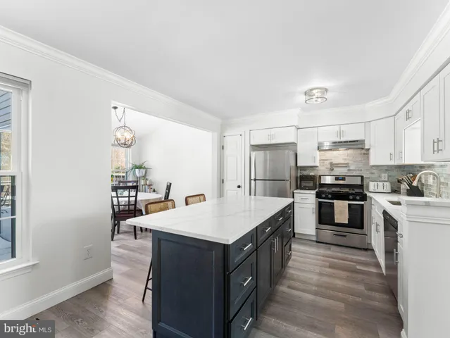 a kitchen with a stove a sink and a refrigerator