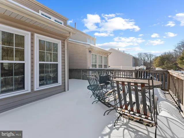 a balcony with table and chairs