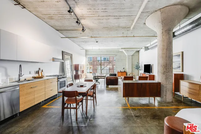 a living room with furniture a dining table and a stove