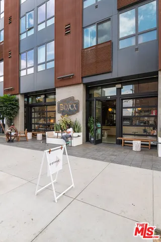 a building outdoor space with patio furniture and potted plants