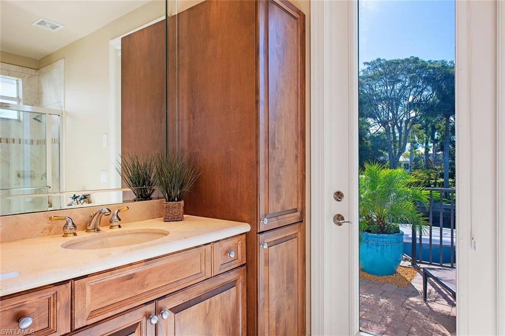 1448 Marlin Drive Naples, FL 34102 - Photo 15 of 23 a bathroom with a sink and a mirror