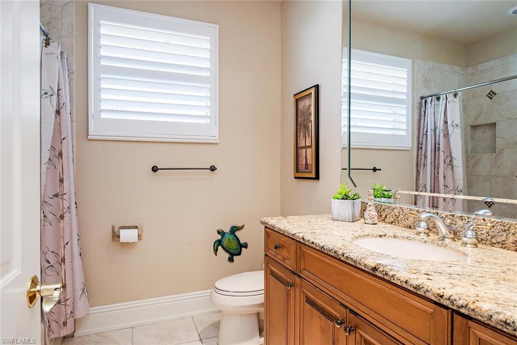 1448 Marlin Drive Naples, FL 34102 - Photo 17 of 23 a bathroom with a granite countertop sink and a mirror