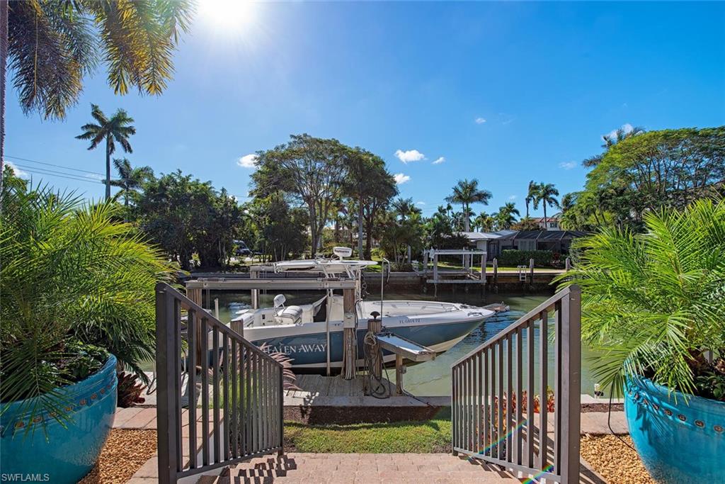 1448 Marlin Drive Naples, FL 34102 - Photo 2 of 23 a view of house with outdoor space and seating area