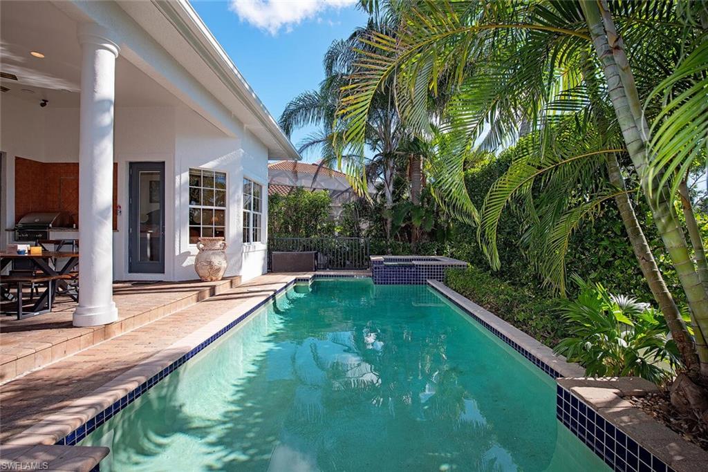 1448 Marlin Drive Naples, FL 34102 - Photo 4 of 23 a view of a house with swimming pool and sitting area