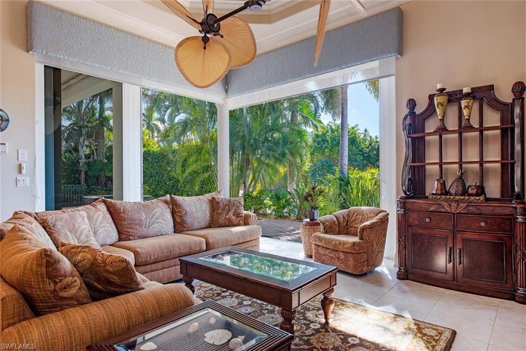 1448 Marlin Drive Naples, FL 34102 - Photo 5 of 23 a living room with furniture a rug potted plant and a large window