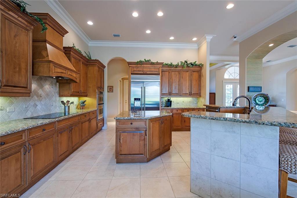 1448 Marlin Drive Naples, FL 34102 - Photo 7 of 23 a large kitchen with stainless steel appliances kitchen island granite countertop a large counter top a stove and a sink