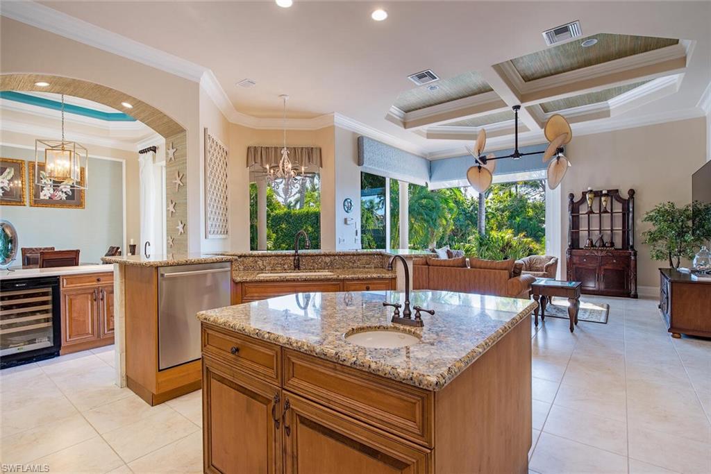 1448 Marlin Drive Naples, FL 34102 - Photo 8 of 23 a kitchen with counter top space and windows