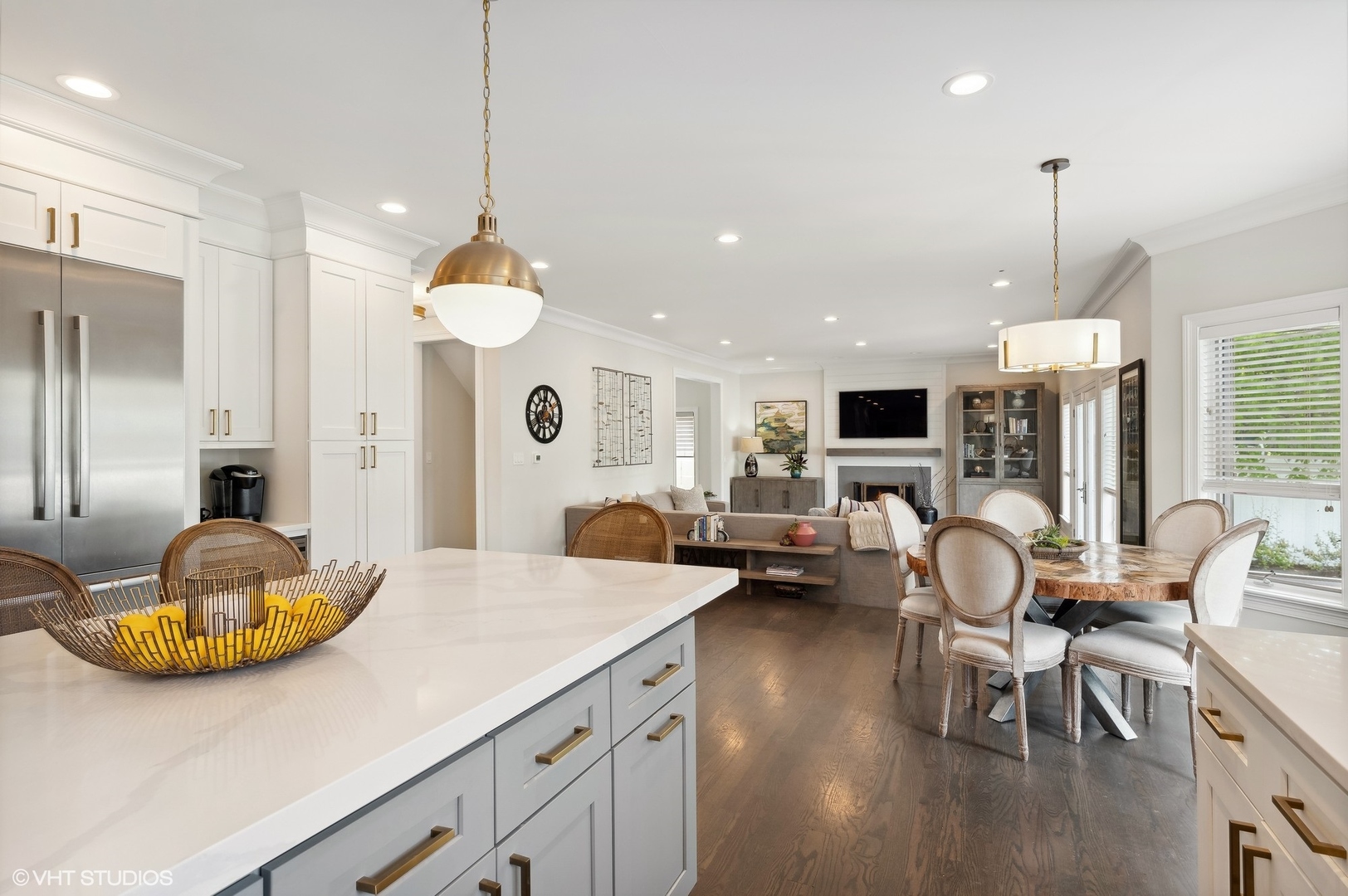 1770 Harrison Street Glenview, IL 60025 - Photo 15 of 40 a kitchen with stainless steel appliances kitchen island granite countertop a stove white cabinets a dining table and chairs with wooden floor