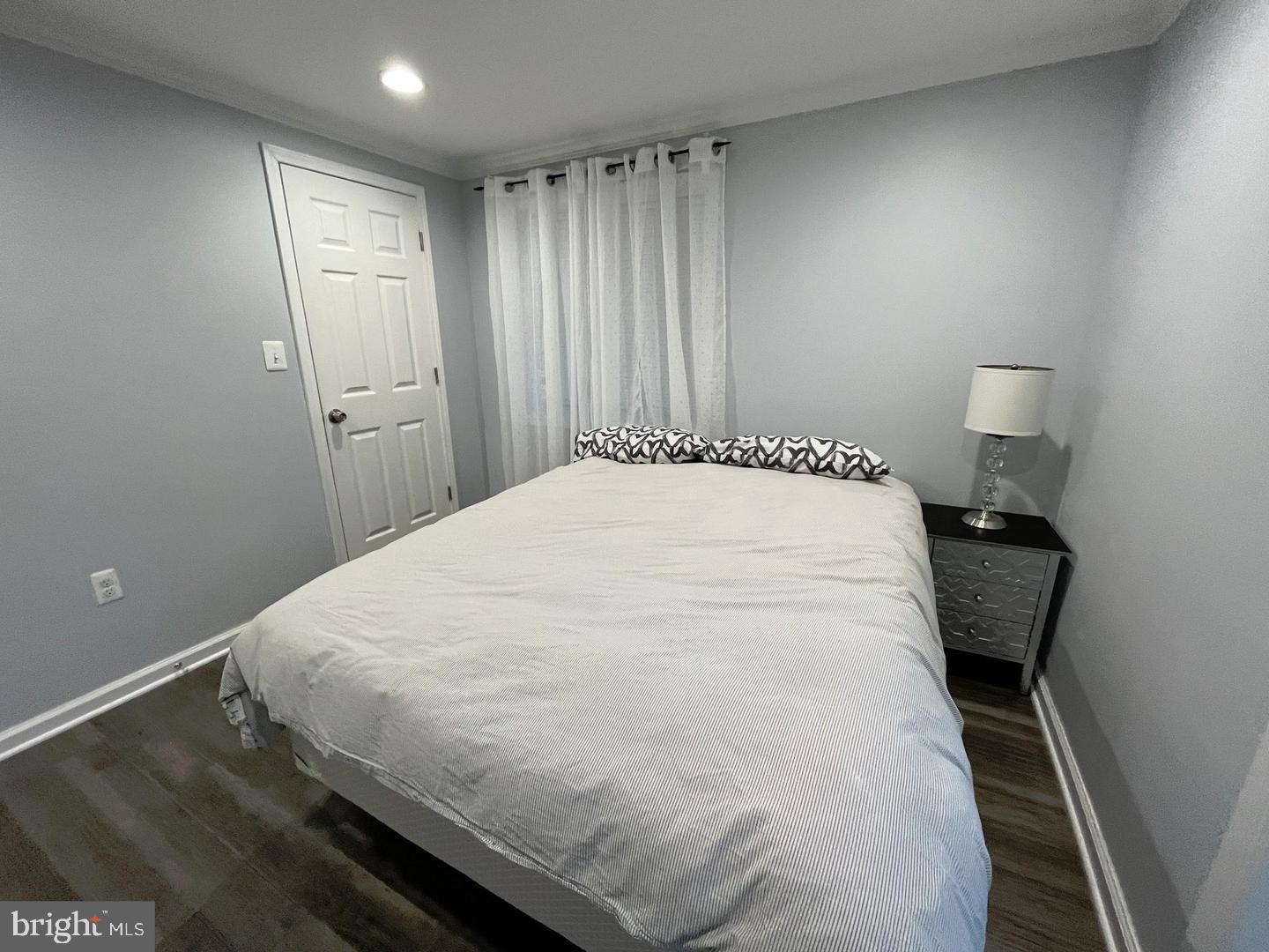 1077 South Edison Street Arlington, VA 22204 - Photo 13 of 29 a large white bed in a small room