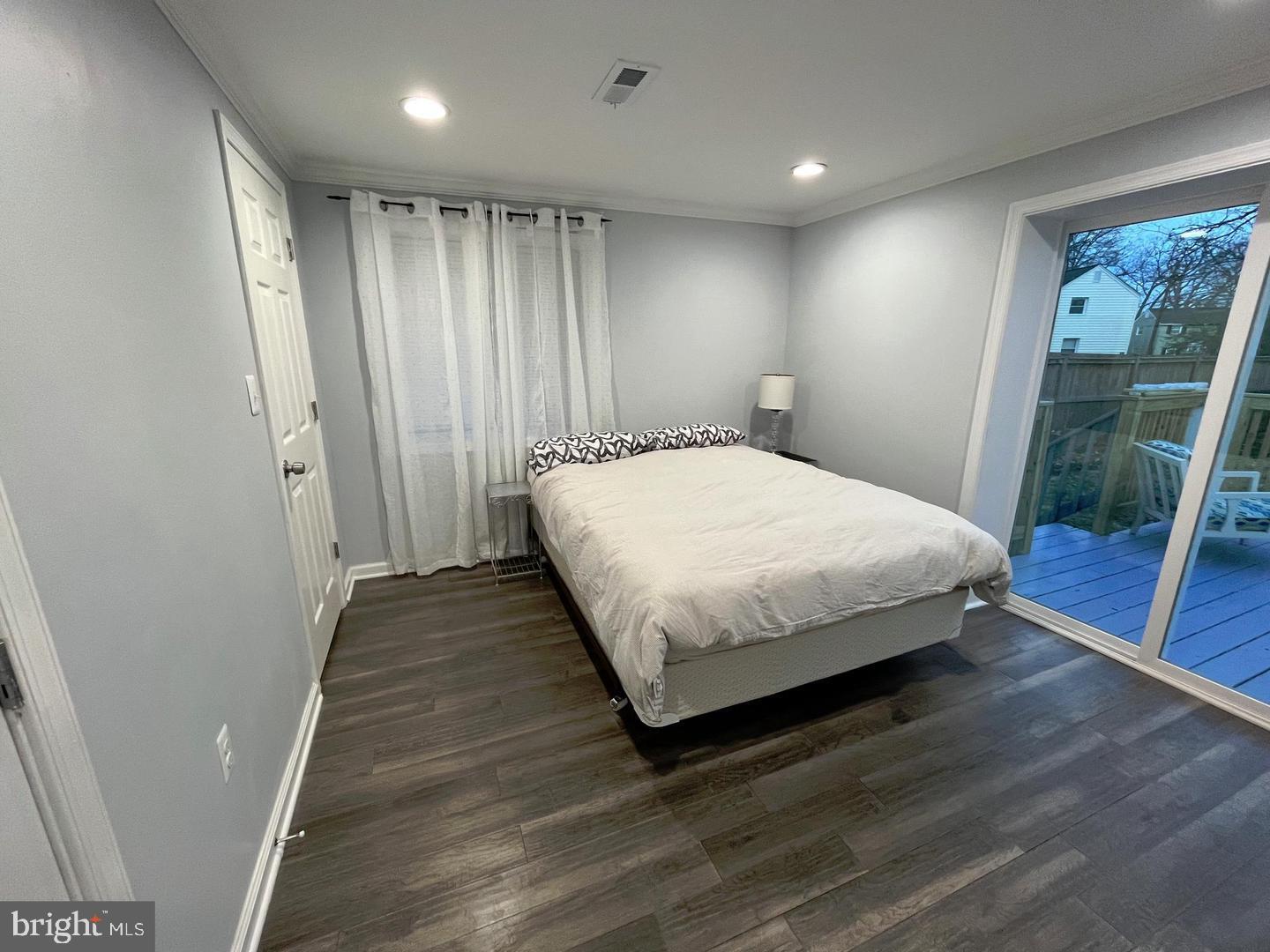 1077 South Edison Street Arlington, VA 22204 - Photo 14 of 29 a large bed sitting in a room next to a window