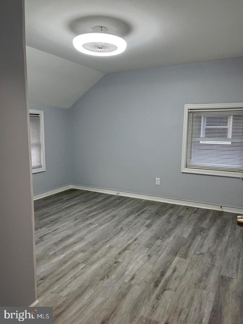 1077 South Edison Street Arlington, VA 22204 - Photo 20 of 29 an empty room with wooden floor and windows