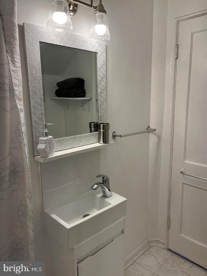 1077 South Edison Street Arlington, VA 22204 - Photo 21 of 29 a bathroom with a sink and a mirror