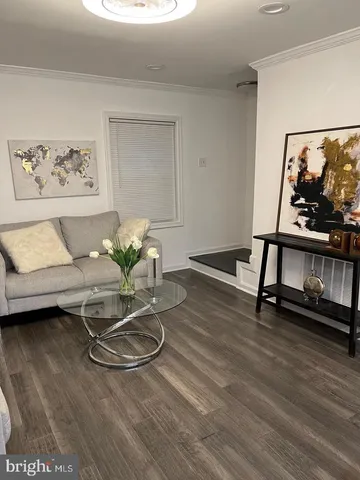 a dining room with wooden floor and a glass table