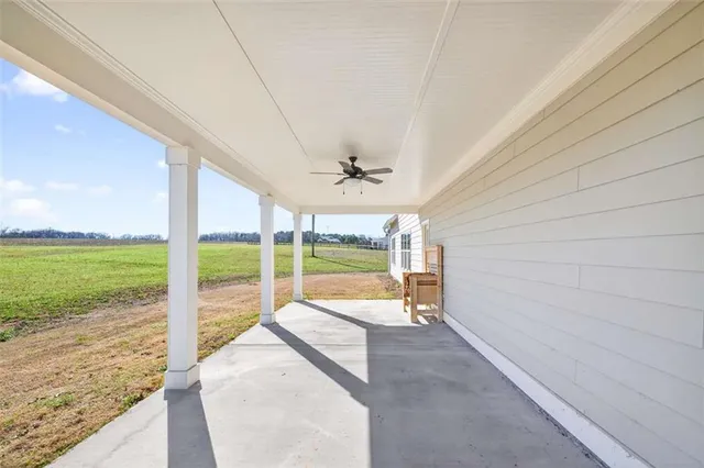 an aerial view of a house with a yard table and chairs