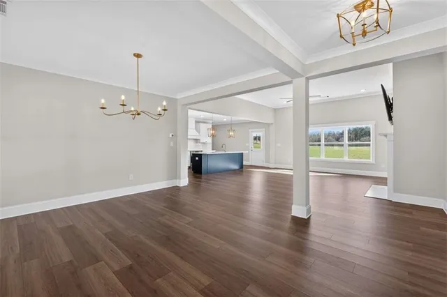 a view of a livingroom with a fireplace a ceiling fan and windows