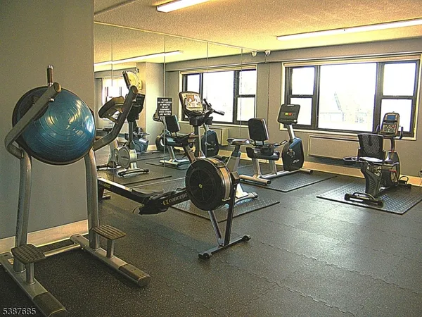 a room with gym equipment and view of living room