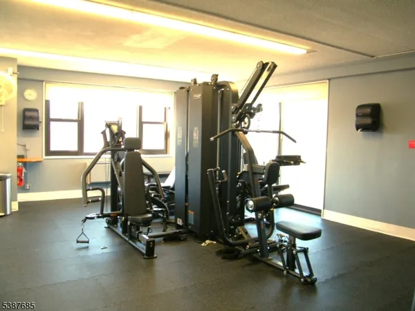 a room with gym equipment and a large window