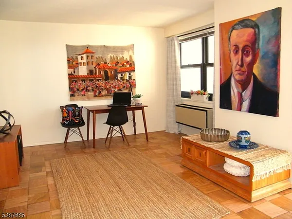 a living room with furniture and a wall painting
