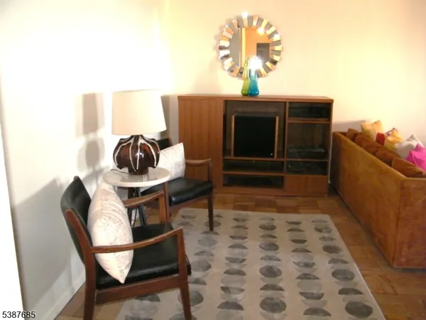 a living room with a couch and chairs