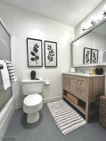 a bathroom with a toilet a sink and a mirror