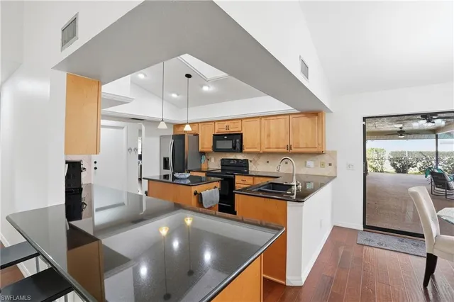 a kitchen with stainless steel appliances a stove a sink and a refrigerator